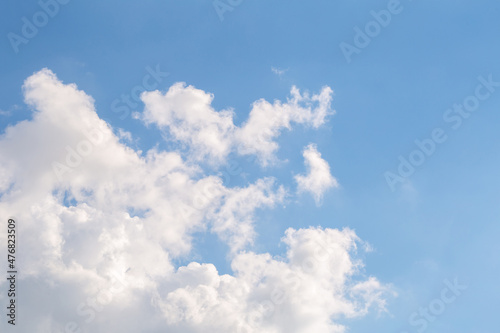 Blue sky with fluffy clouds on a sunny day