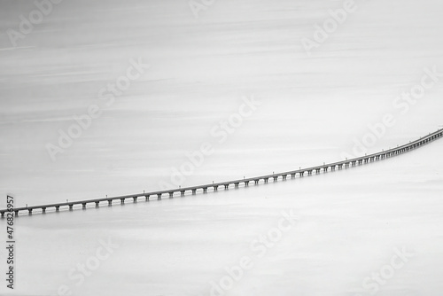 Black and white photo of Floating railway bridge popular travel destination in the middle of 