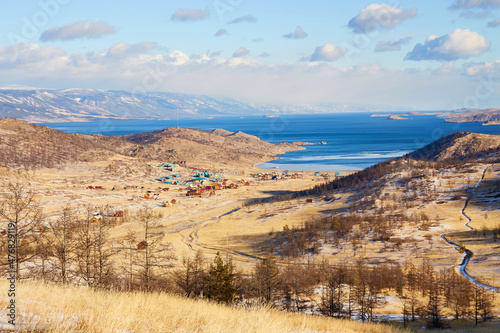 Lake Baikal in early December. Beautiful view of the coast of the Small Sea  Kurkut Bay  tourist camps and wooden hotel houses.