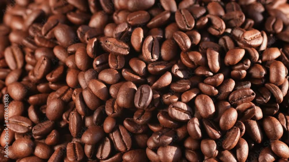Close up of seeds of coffee. Fragrant coffee beans are rotate Close up of seeds of coffee. Fragrant coffee beans are rotate