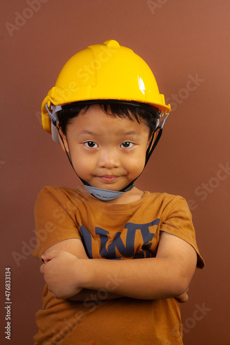 Close-up portrait of asian child boy he engineering looking creating new idea solution fantasize copy space isolated brown color background
