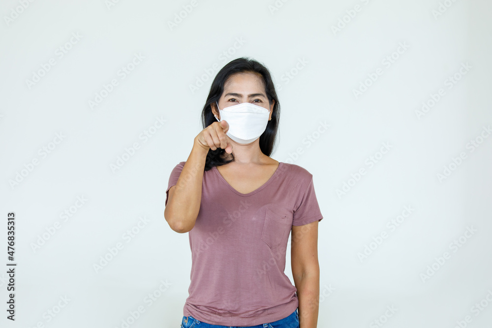 Portrait Asian woman wearing a face mask poses, pointing advertisement on white background, blank copy space with isolated cutout. Portrait Asian woman wearing a face mask poses, pointing advertisement on white background, blank copy space with isolated cutout.