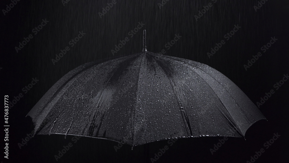 Photo of the black umbrella and rainy drops on black background - obrazy, fototapety, plakaty 