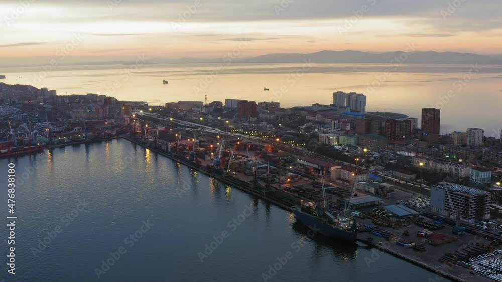 Drone view of the cargo terminal with port cranes at sunset Drone view of the cargo terminal with port cranes at sunset