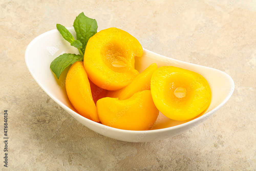 Sweet ripe canned peaches with mint