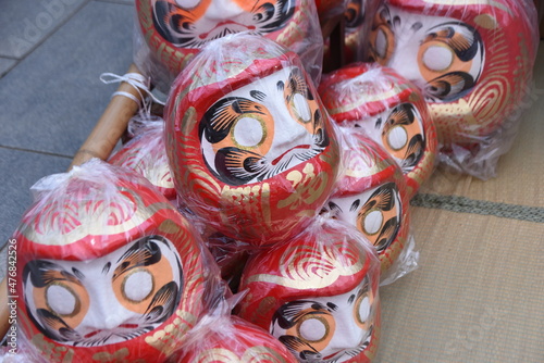 Daruma doll market and festival. Daruma is loved by Japanese as a talisman. It is considered a symbol of perseverance because Daruma always comes upright position every time after it tumbles. 