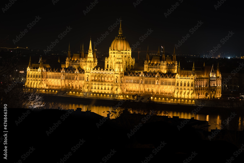 Fototapeta premium The iconique Budapest parlement in Hungary, the biggest building in Europe during the night shining. This is a rare view of the Parlament
