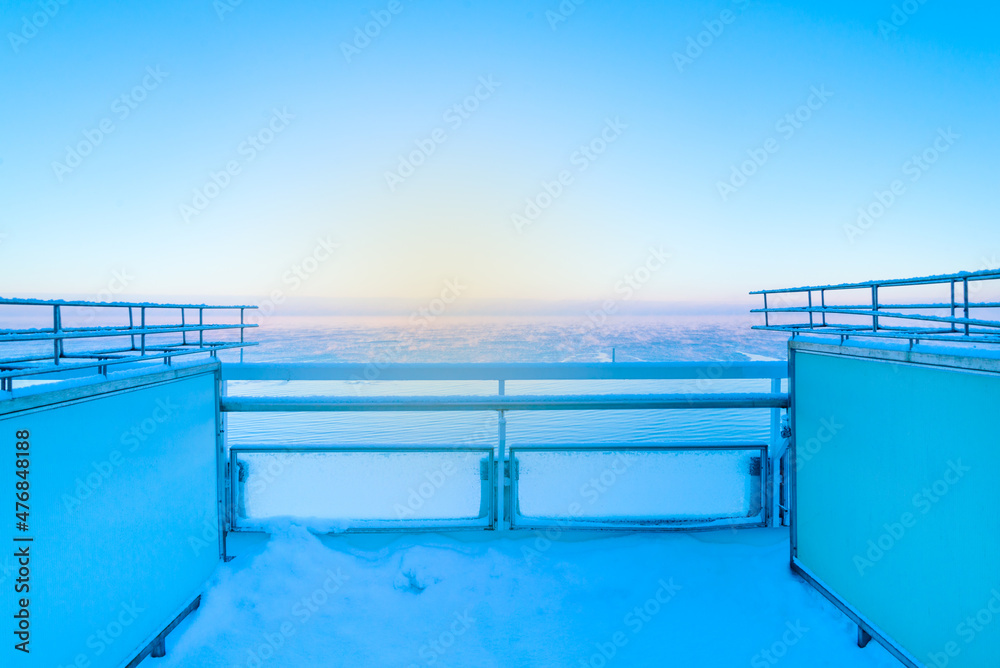 Empty terrace on winter snowy beach, off season on Baltic sea