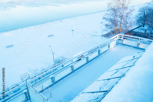 Empty terrace on winter snowy beach, off season on Baltic sea