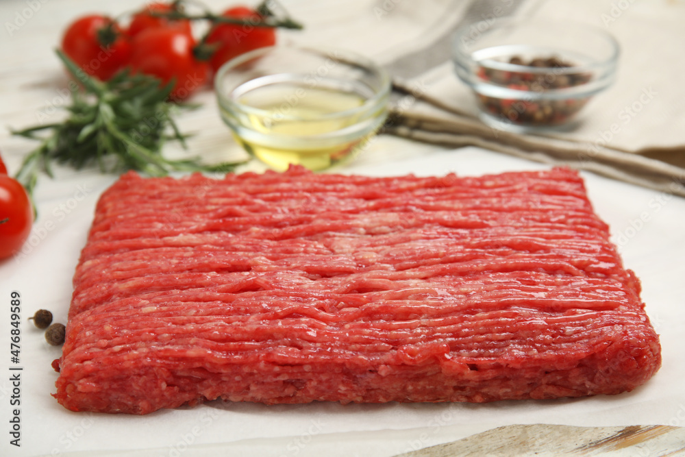 Raw fresh minced meat on white wooden table, closeup