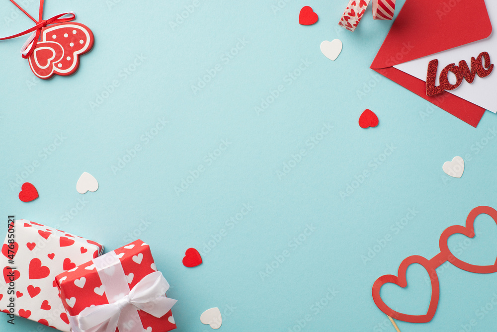 Top view photo of valentine's day decor gift boxes hearts adhesive tape envelope with letter inscription love heart shaped paper glasses and confetti on isolated pastel blue background with copyspace