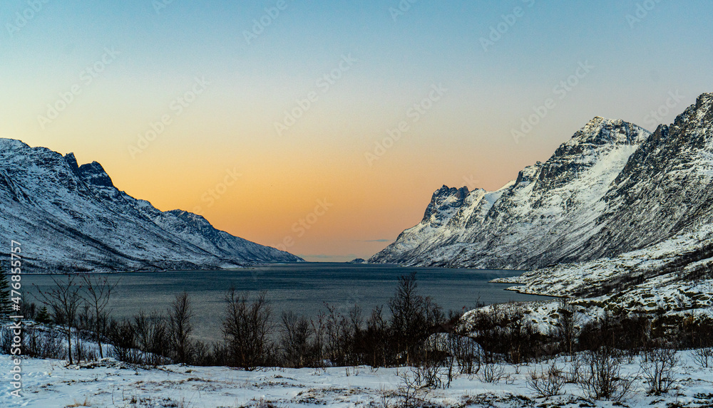 Norwegian Fjord with snowy mountains and a Norwegian Fjord with snowy mountains and a
