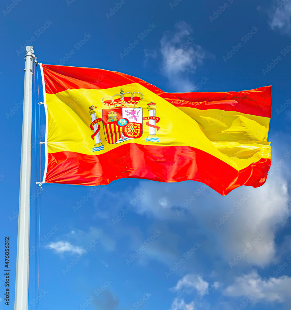 Spanish state flag waving in the wind against the sky Spanish state flag waving in the wind against the sky
