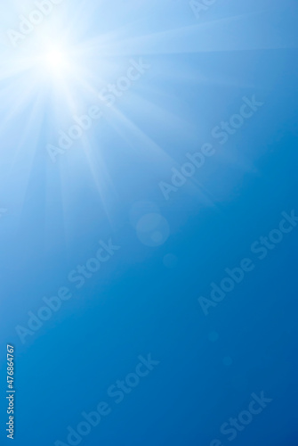 Blue summer sky with bright sun as background