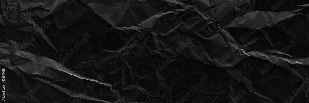 Black crumpled paper texture with folds banner. Black grunge surface. Black wallpaper background. Black crumpled paper texture with folds banner. Black grunge surface. Black wallpaper background.