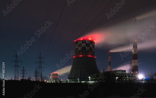 thermal power plant cooling towers soar in winter at night