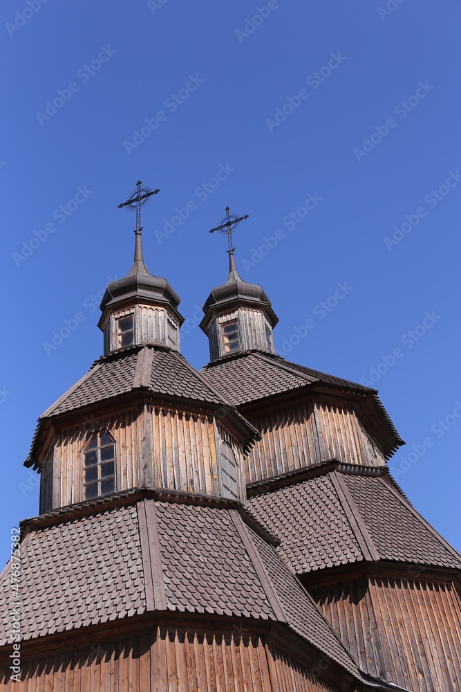 Orthodox church in Ukraine, old church on blu sky the background. Old temple made of wood . religion, Orthodox church in Ukraine, old church on blu sky the background. Old temple made of wood . religion,