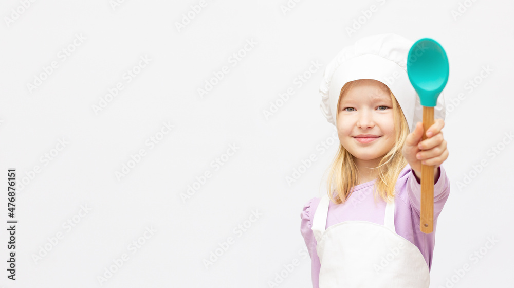 Beautiful little girl in chef uniform isolated on white banner copy space Beautiful little girl in chef uniform isolated on white banner copy space