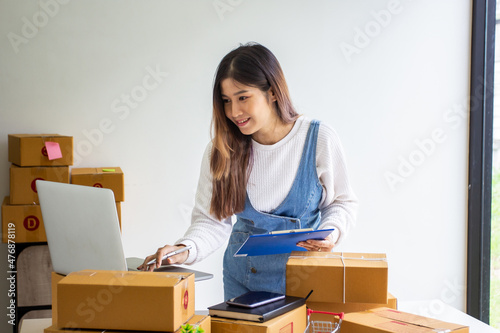 Online business owner checking customer name and address ordering company products, Cropped image of woman checking customer address online for delivery at online sales office.