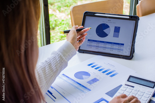 The sales manager points out the company's past sales, cropped image of working woman of her own company by self-checking and troubleshooting, new business ideas.