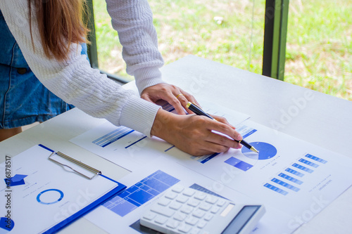 Accounting staff calculates the company's past sales and expenses, cropped image of working women of their own company by self-examination and troubleshooting, new business ideas and finances.