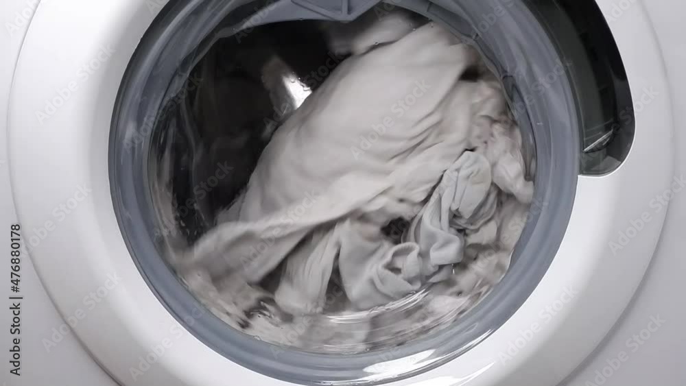 Washing clothes in a washing machine. Slow motion. Washing clothes in a washing machine. Slow motion.