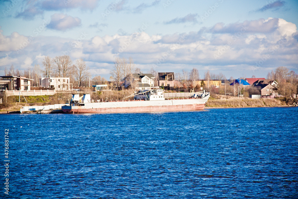 close-up river panorama with a cargo ship in the background 