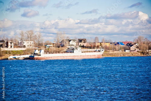 close-up river panorama with a cargo ship in the background 