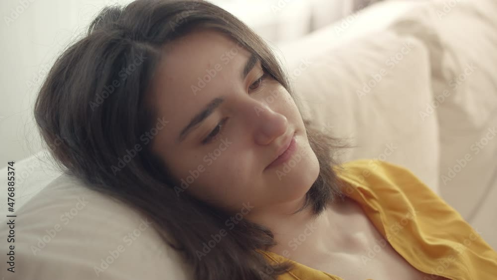 Portrait of cute smiling brunette girl relaxing on sofa, comfort zone Portrait of cute smiling brunette girl relaxing on sofa, comfort zone