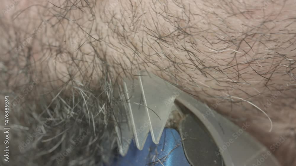 Extreme close-up of a man shaving in the bathroom Extreme close-up of a man shaving in the bathroom