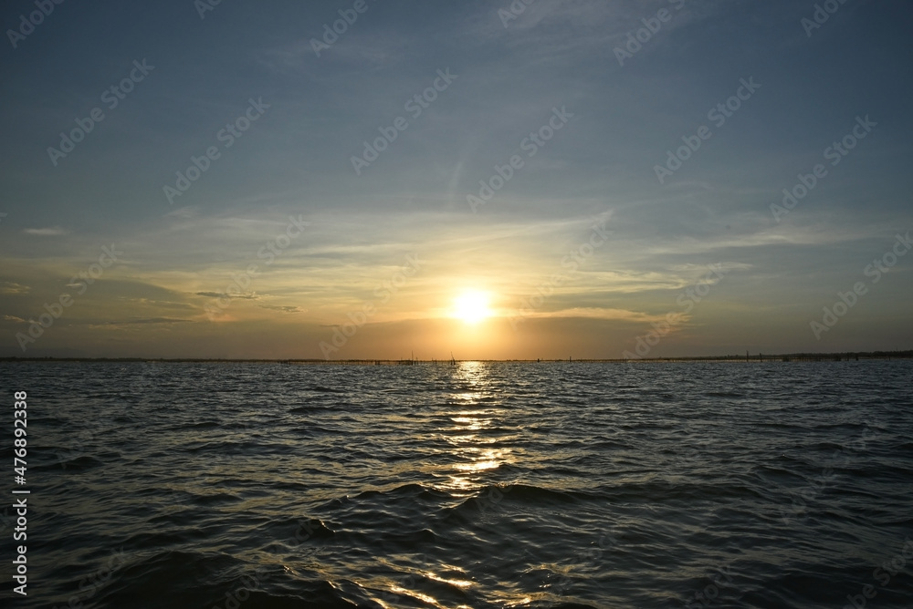 Seascape with a beautiful sunset, there are fishing nets in the sea