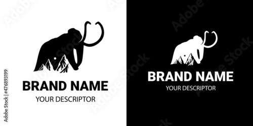 mountains the background of an adult mammoth with powerful tusks