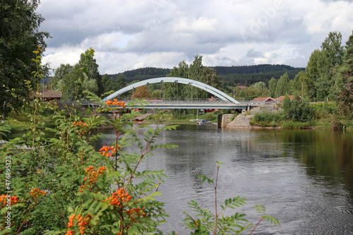 Cloudy summer day in Järvsö, view at a bridge over Ljusnan river between mainland and Island Kyrkön. photo