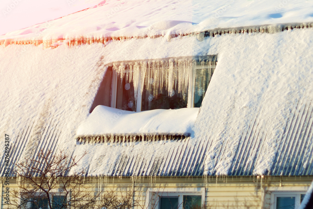 Icicles in winter. A frozen window in house. Winter season Icicles in winter. A frozen window in house. Winter season