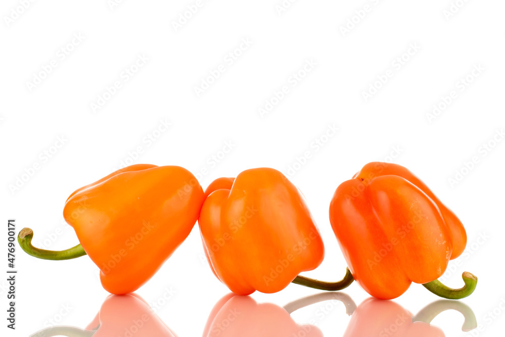 Three ripe orange sweet peppers, close-up, isolated on white. Three ripe orange sweet peppers, close-up, isolated on white.