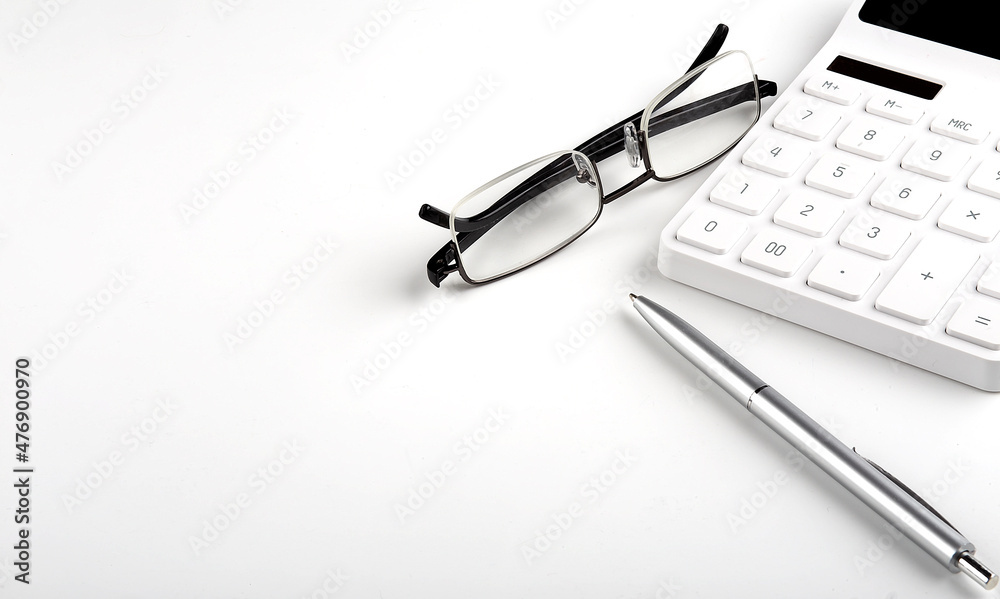 Calculator and pen and glasses on white background Calculator and pen and glasses on white background