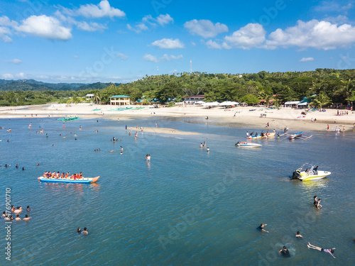 A throngs of vacationers in the popular destination of Laiya Beach, San Juan, Batangas, Philippines. photo