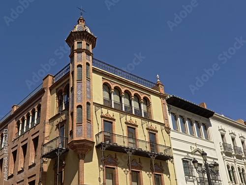  Posh historical Andalusian house with tower on a sunny day with clear blue sky in Seville, Spain 