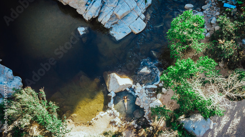 Drone view on girl swimming in hot springs at the Deep Creek hot springs, Southern California, USA