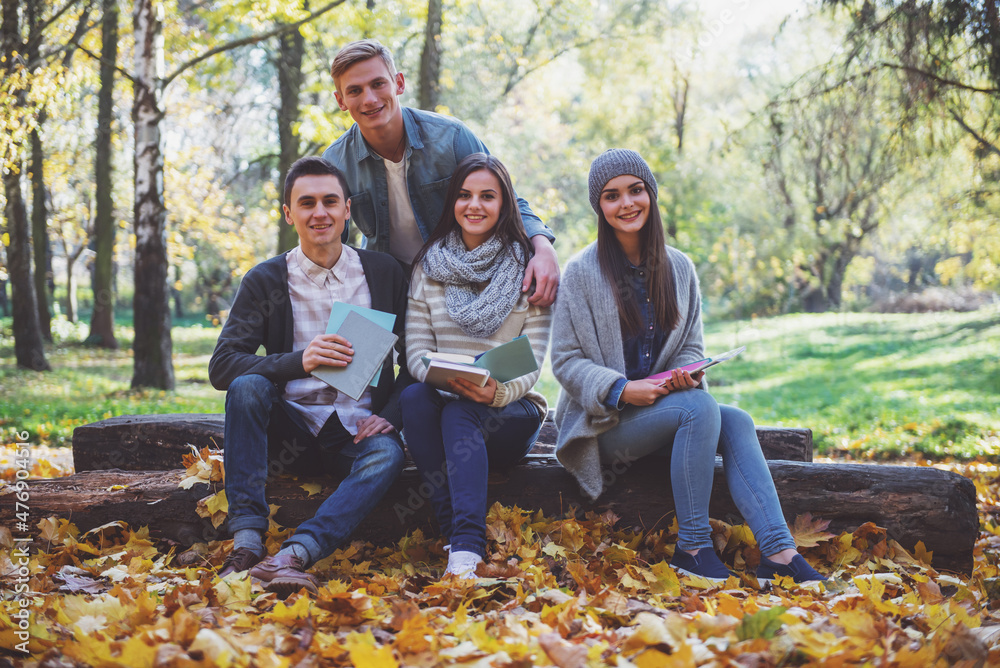 Students in autumn park Students in autumn park