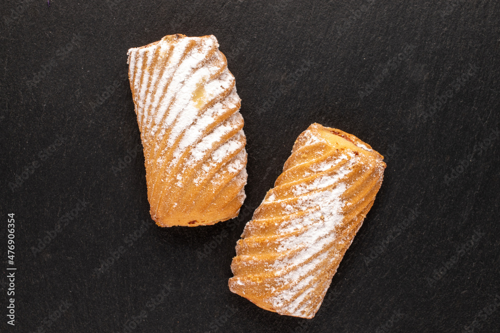 Two homemade cookies stuffed with jam on a slate stone, close-up, top view. Two homemade cookies stuffed with jam on a slate stone, close-up, top view.
