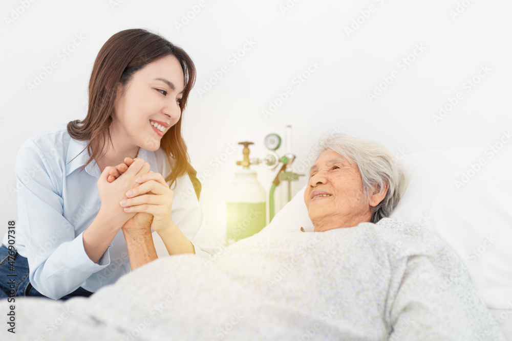 old asian patient sick and admit in hospital, young asian female visiting old female, they holding hands together, they feeling happy and smile, elderly healthcare old asian patient sick and admit in hospital, young asian female visiting old female, they holding hands together, they feeling happy and smile, elderly healthcare
