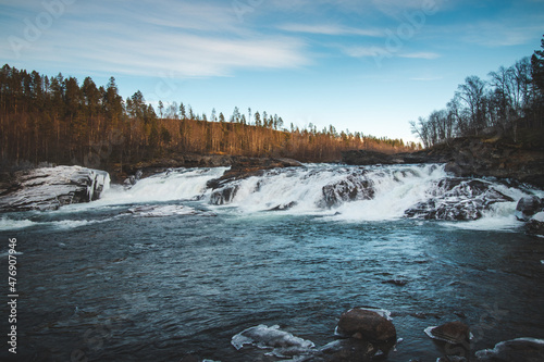 Spectacular Malselvfossen waterfall on the Malselva River in northern Norway, on the Scandinavian peninsula. Sunset. The power of water. Waterfall in north of Norway near Bardufoss in region Troms photo