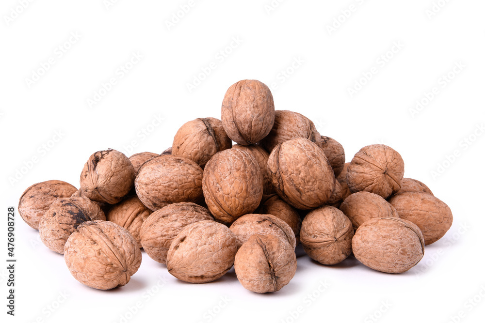 Walnuts stacked in a bunch, photographed close-up on a white background Walnuts stacked in a bunch, photographed close-up on a white background