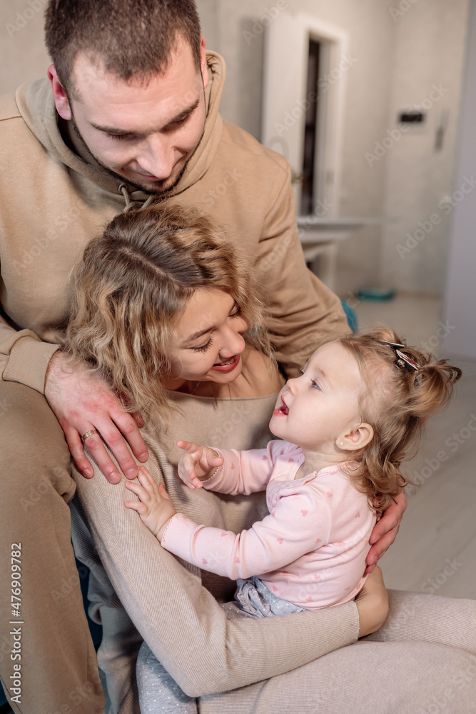 Young family with a little daughter and beautiful parents  at home