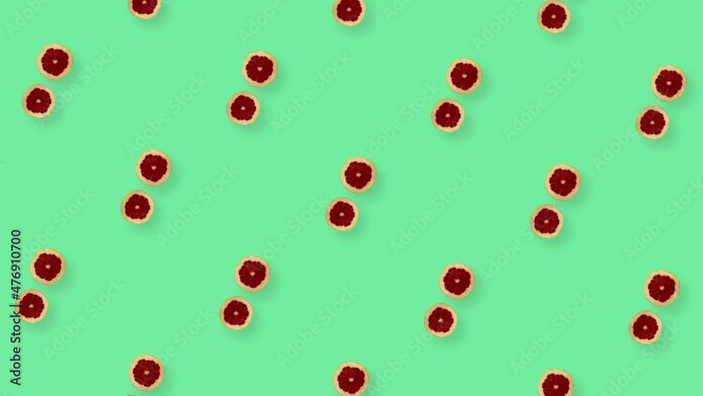 Colorful fruit pattern of fresh rotating grapefruits on green background. Seamless pattern with grapefruit slices. Realistic animation. 4K video motion Colorful fruit pattern of fresh rotating grapefruits on green background. Seamless pattern with grapefruit slices. Realistic animation. 4K video motion