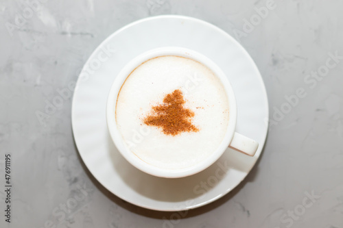 cappuccino coffee cup with cinnamon pattern, christmas drink,on concrete background