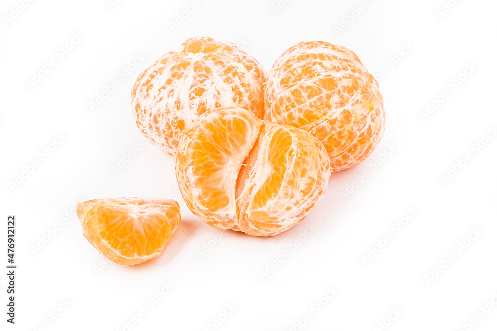 white background. several peeled tangerines. the slice lies ahead. close-up. white background. several peeled tangerines. the slice lies ahead. close-up.