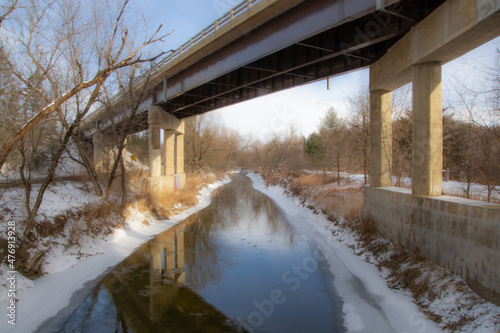 In december, icy river under the bridge in the Canadian winter in the province of Quebec