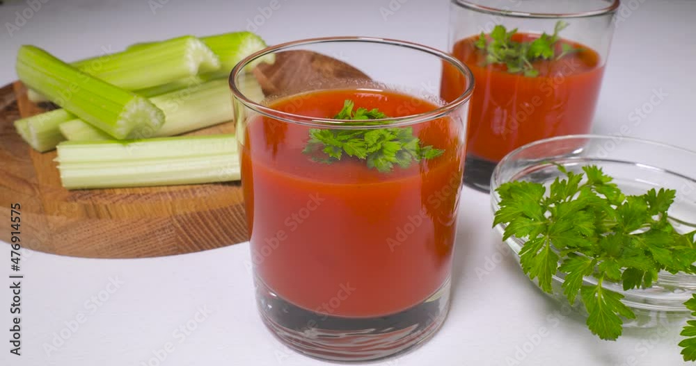 Glasses of tomato juice on table Glasses of tomato juice on table